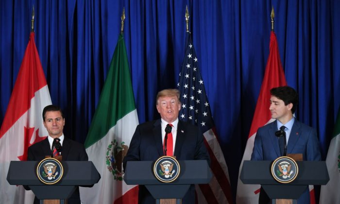 (L to R) Mexican President Enrique Pena Nieto, U.S. President Donald Trump, and Canadian Prime Minister Justin Trudeau deliver a statement on the signing of the USMCA trade agreement in Buenos Aires on the sidelines of the G20 Leaders' Summit, on Nov. 30, 2018. (MARTIN BERNETTI/AFP/Getty Images)
