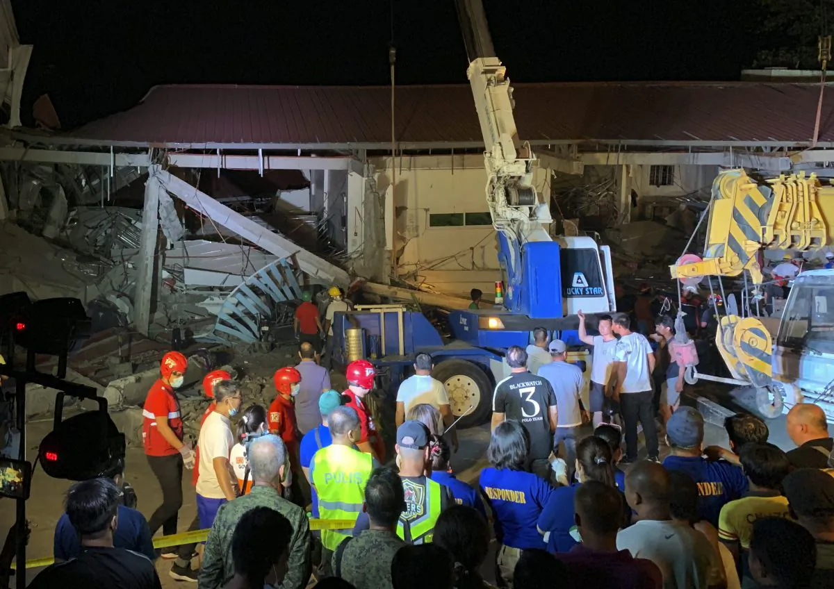 Workers continue rescue efforts on people still trapped inside a collapsed building at Porac town, Philippines on April 22, 2019. A strong 6.1 magnitude earthquake trapped some people in a collapsed building, damaged an airport terminal and knocked out power in at least one province, officials said. AP Photo/Bullit Marquez