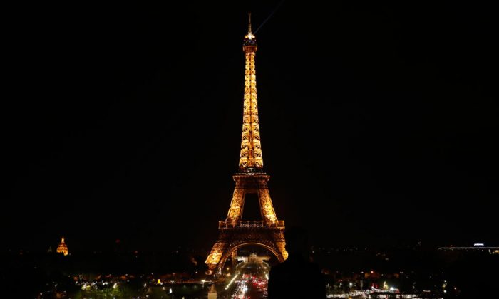 The Eiffel Tower is seen illuminated just before midnight in Paris, on April 21, 2019. (ZAKARIA ABDELKAFI/AFP/Getty Images)