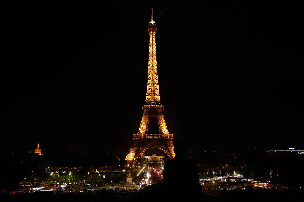 The Eiffel Tower is seen illuminated just before midnight in Paris, on April 21, 2019. (ZAKARIA ABDELKAFI/AFP/Getty Images)