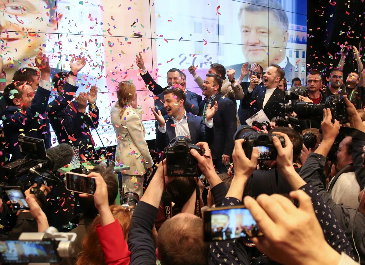 Ukrainian presidential candidate Volodymyr Zelenskiy and his team members react following the announcement of the first exit poll in a presidential election at his campaign headquarters in Kiev, Ukraine, on April 21, 2019. (Viacheslav Ratynskyi/Reuters)
