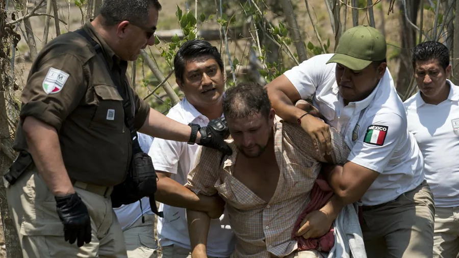 A Central American migrant is detained by Mexican immigration agents on the highway to Pijijiapan, Mexico, on April 22, 2019. (Moises Castillo/AP Photo)