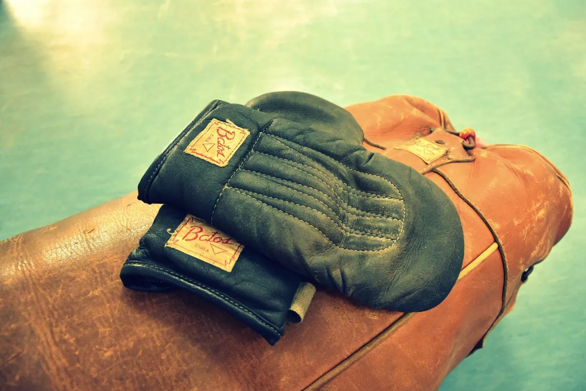 File photo for illustration purposes showing retro boxing gloves on top of a heavy bag. (Pixabay)