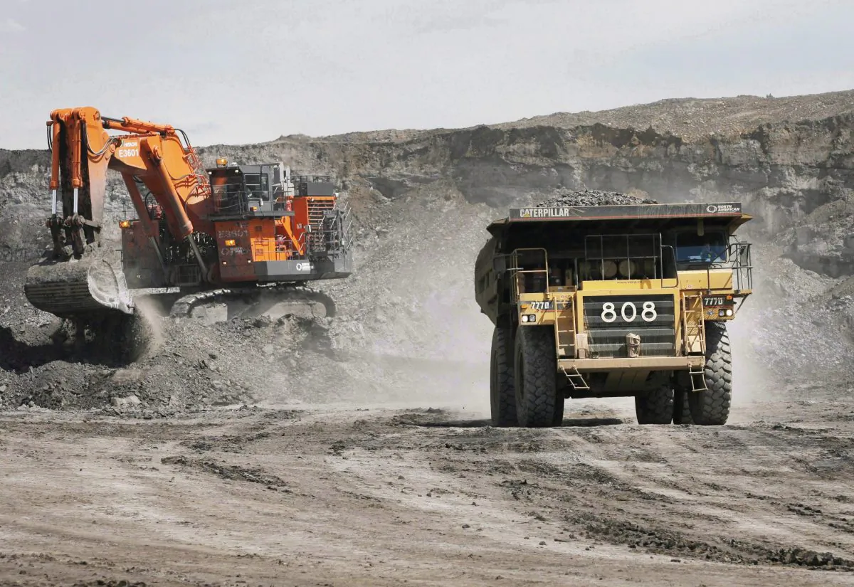 A haul truck carrying a full load drives away from a mining shovel at an oilsands mine near Fort McMurray, Alta., in this file photo. (The Canadian Press/Jeff McIntosh)