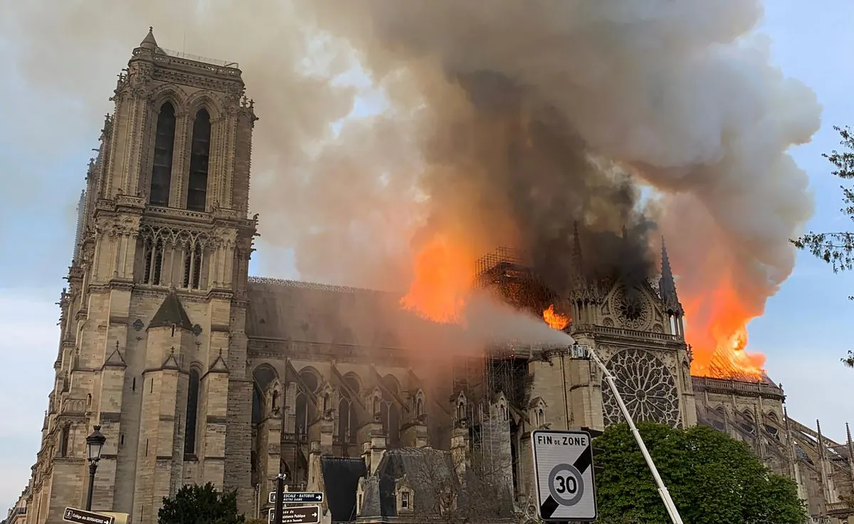 Flames and smoke are seen billowing from the roof at Notre-Dame Cathedral in Paris on April 15, 2019. A fire broke out at the landmark Notre-Dame Cathedral in central Paris, potentially involving renovation works being carried out at the site, the fire service said. (Patrick Anidjar/AFP/Getty Images)
