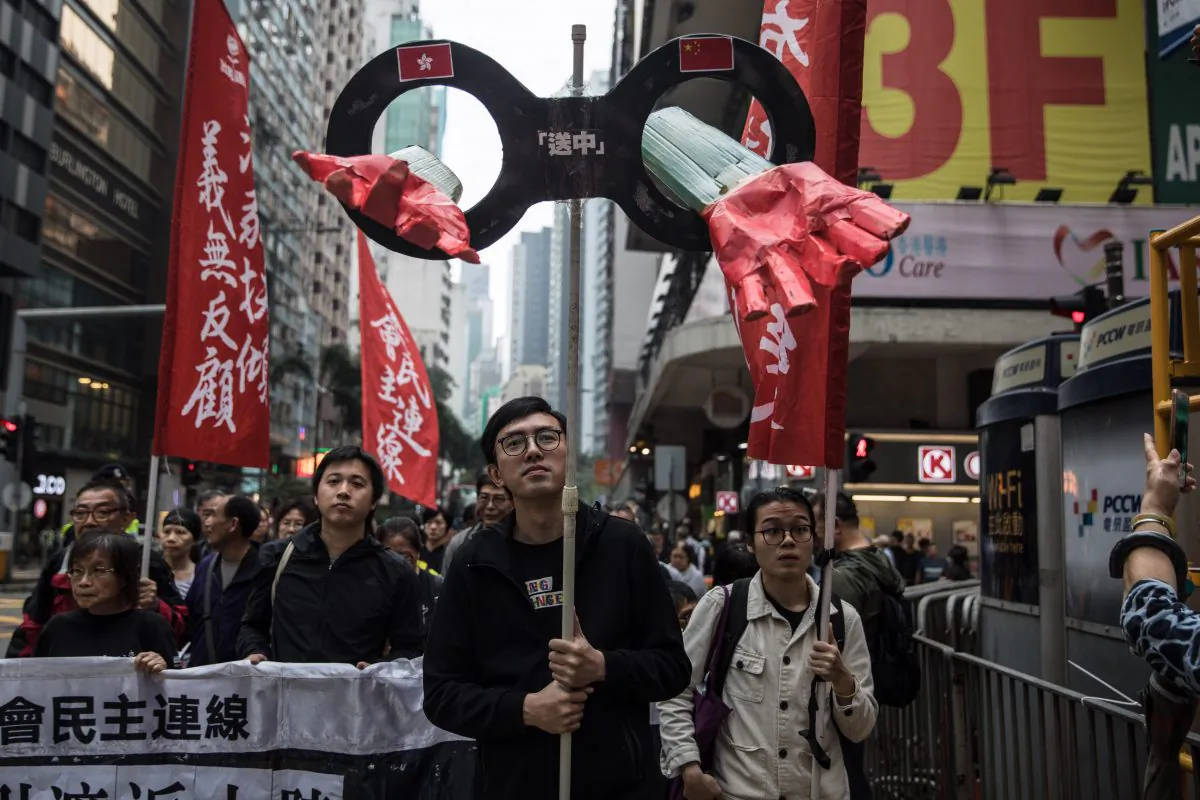 Protesters march along a street during a rally to protest against the government's plans to approve extraditions with mainland China in Hong Kong on March 31, 2019. (DALE DE LA REY/AFP/Getty Images)