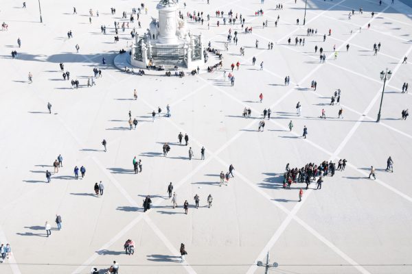 Tourists walk at Comercio square in downtown Lisbon
