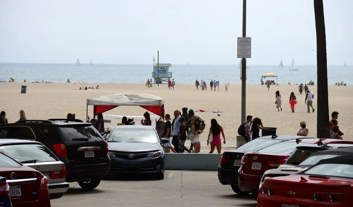 People walk on the Venice Beach boardwalk on Aug. 4, 2013. (Robyn Beck/AFP/Getty Images)