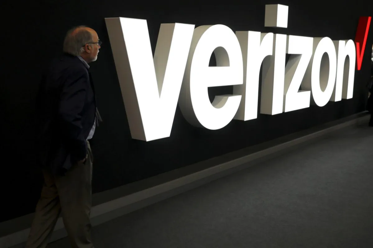 A man stands next to the logo of Verizon at the Mobile World Congress in Barcelona, Spain, Feb. 26, 2019. (Sergio Perez/Reuters)