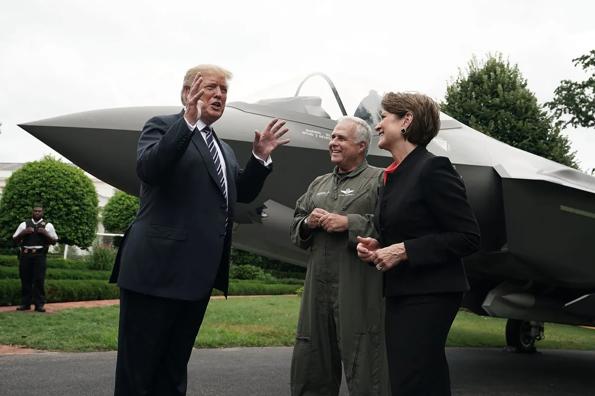 U.S. President Donald Trump (L) talks to Chairman, President and CEO of Lockheed Martin Marillyn Hewson (R) and Director and Chief Test Pilot Alan Norman (2nd L) in front of an F-35 fighter jet during the 2018 Made in America Product Showcase at the White House in Washington, DC. on July 23, 2018. (Alex Wong/Getty Images)