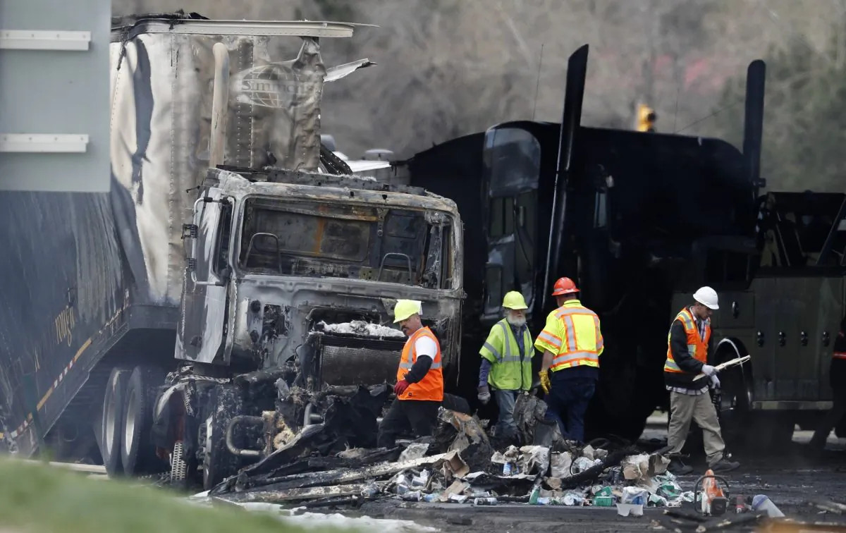 Workers clear debris from the eastbound lanes of Interstate 70, on April 26, 2019, in Lakewood, Colo., after a deadly pileup involving semi-truck hauling lumber on April 25, 2019. (David Zalubowski/AP Photo)