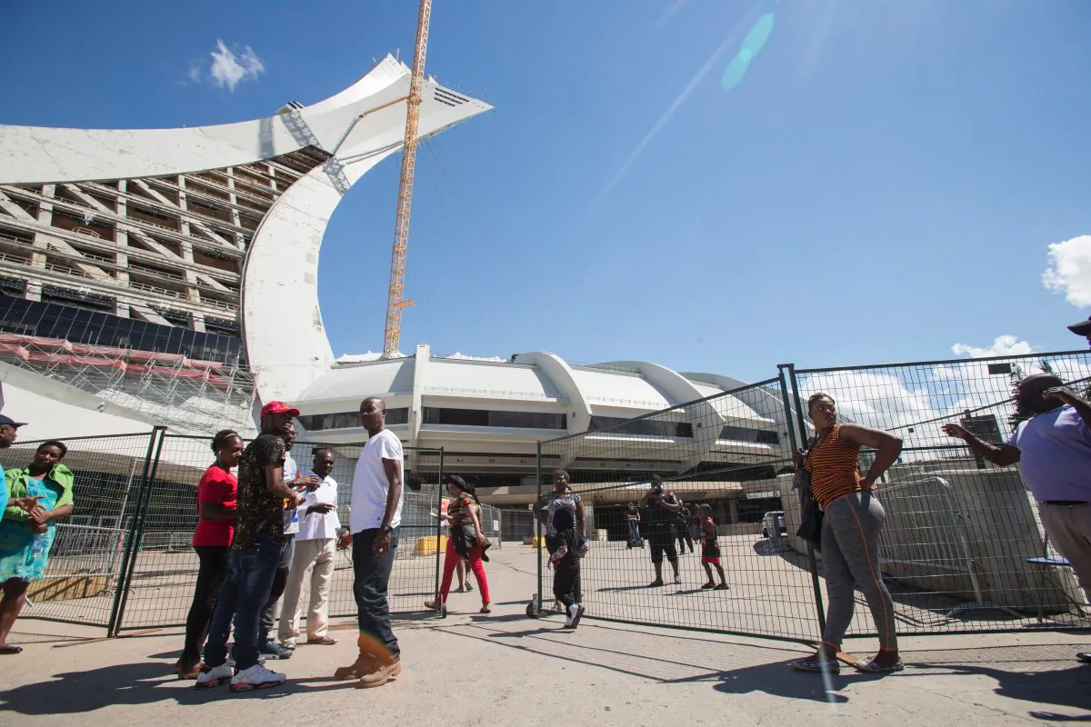 Refugees and some of their Canadian supporters mingle outside Olympic Stadium in Montreal, Quebec, on Aug. 5, 2017. (Geoff Robins/AFP/Getty Images)