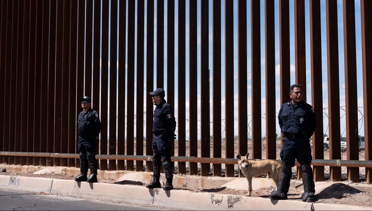 Mexico's federal police stand guard at the US-Mexico border fence as President Donald Trump visits Calexico, California, as seen from Mexicali, Baja California state, Mexico, on April 5, 2019. (GUILLERMO ARIAS/AFP/Getty Images)