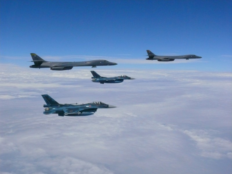 Two U.S. Air Force B-1B Lancer bombers fly from Guam with an escort of a pair of Japan Self-Defense Forces F-2 fighter jets near Kyushu