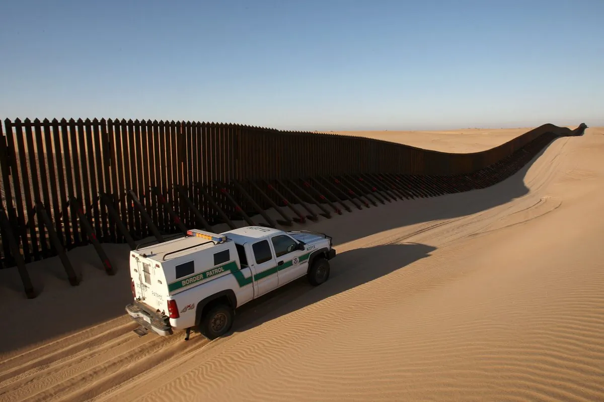 A border patrol vehicle patrols along a recently constructed section of the border fence expansion between Yuma, Ariz., and Calexico, Calif., on March 14, 2009. (David McNew/Getty Images)