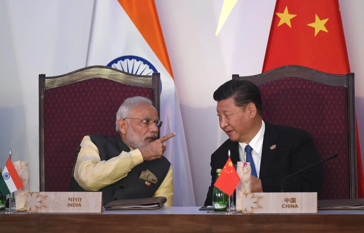 India Prime Minister Narendra Modi (Left) gestures while talking with China's President Xi Jinping during the BRICS leaders' meeting with the BRICS Business Council at the Taj Exotica hotel in Goa on October 16, 2016. (PRAKASH SINGH/AFP/Getty Images)