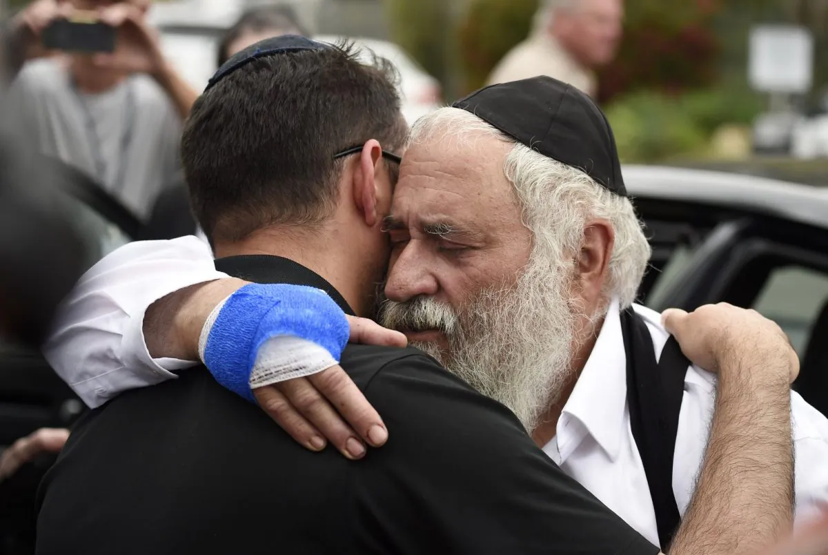 Rabbi Yisroel Goldstein (R) is hugged as he leaves a news conference at the Chabad of Poway synagogue in Poway, Calif., on April 28, 2019. (Denis Poroy/AP Photo)