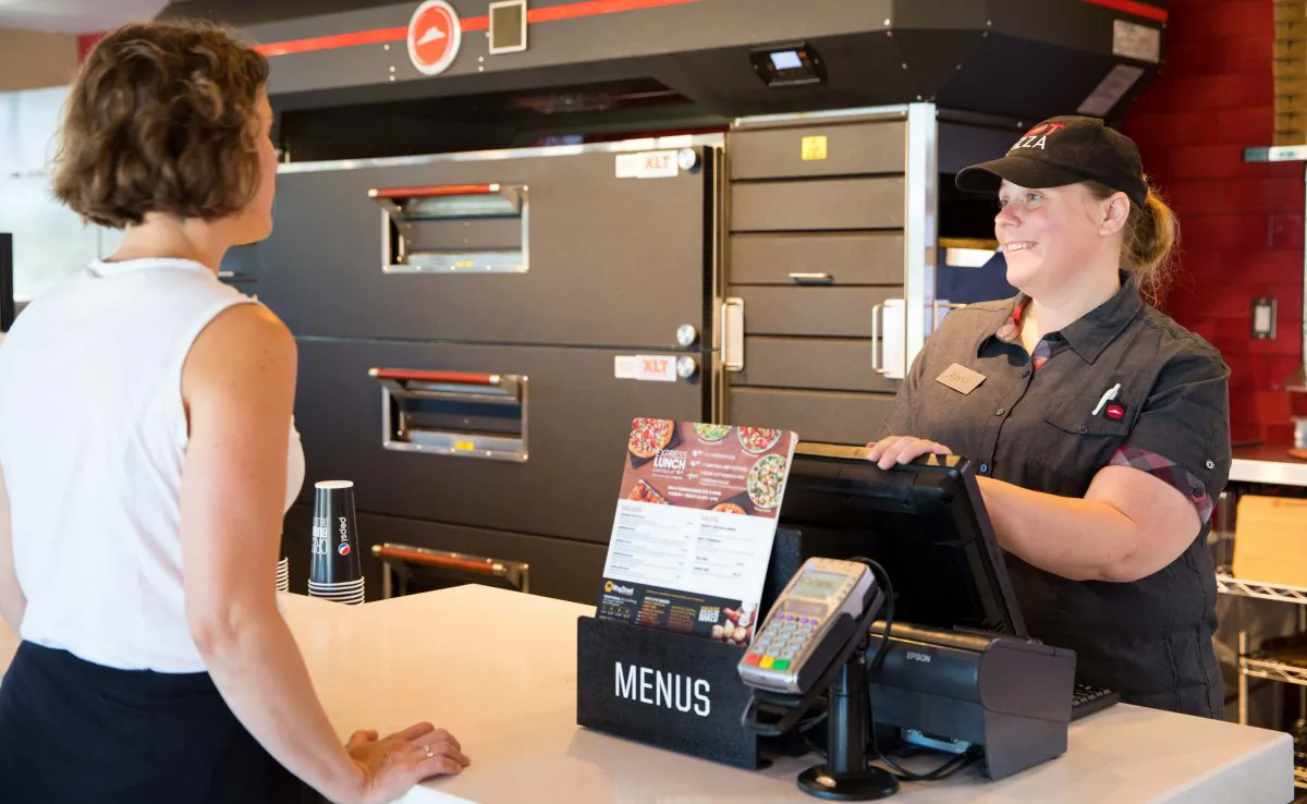A customer service representative takes order at Pizza Hut in Shreveport, La., on June 29, 2018. (Shannon O'Hara/Getty Images for Pizza Hut)