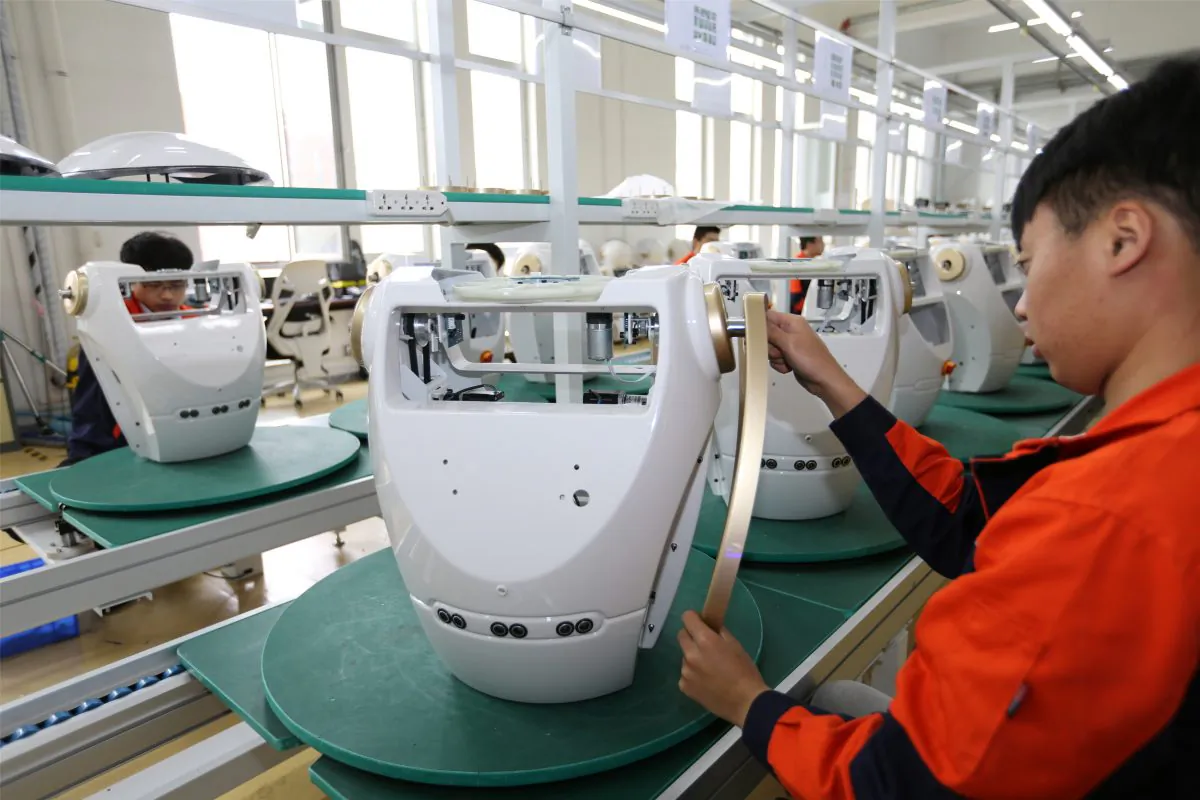 Workers assemble robots at the production line of Chuangze Intelligent Robot in Rizhao, Shandong Province, China on April 29, 2019. (Reuters)