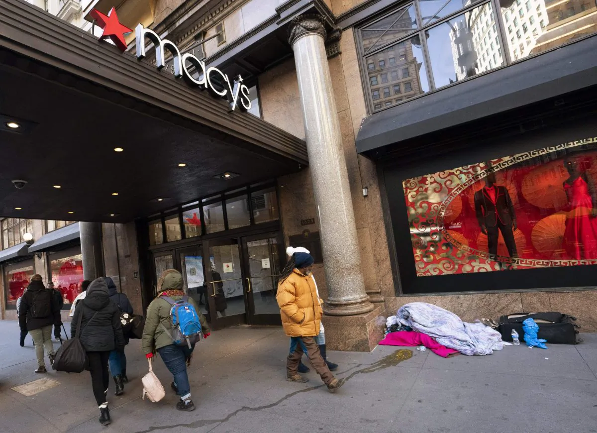 Pedestrians regard a homeless person sleeping outside the Macy's store at Manhattan's Herald Square in New York, on Jan. 11, 2019. (Don Emmert/AFP/Getty Images)