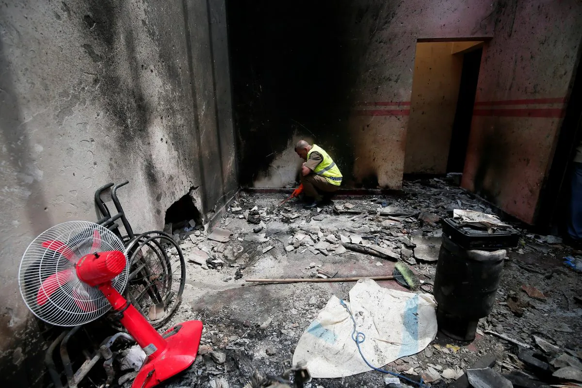 A police officer inspects the site of a gun battle between troops and suspected Islamist terrorists believed to be connected to the Easter Sunday bombings in Kalmunai, Sri Lanka, on April 28, 2019. (Dinuka Liyanawatte/Reuters)
