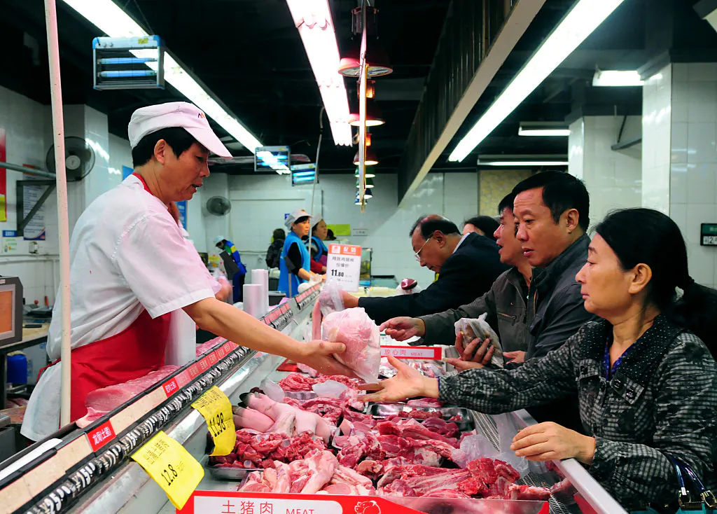 Chinese customers buy pork at a supermarket in Jiujiang, east China's Jiangxi province.(STR/AFP/Getty Images)
