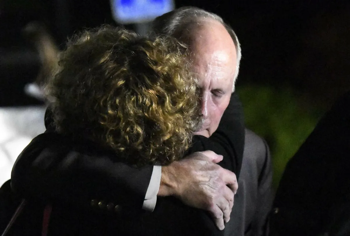 UNC Charlotte Chancellor Philip DuBois is hugged in Charlotte, N.C., on April 30, 2019. (David T. Foster III/The Charlotte Observer via AP)