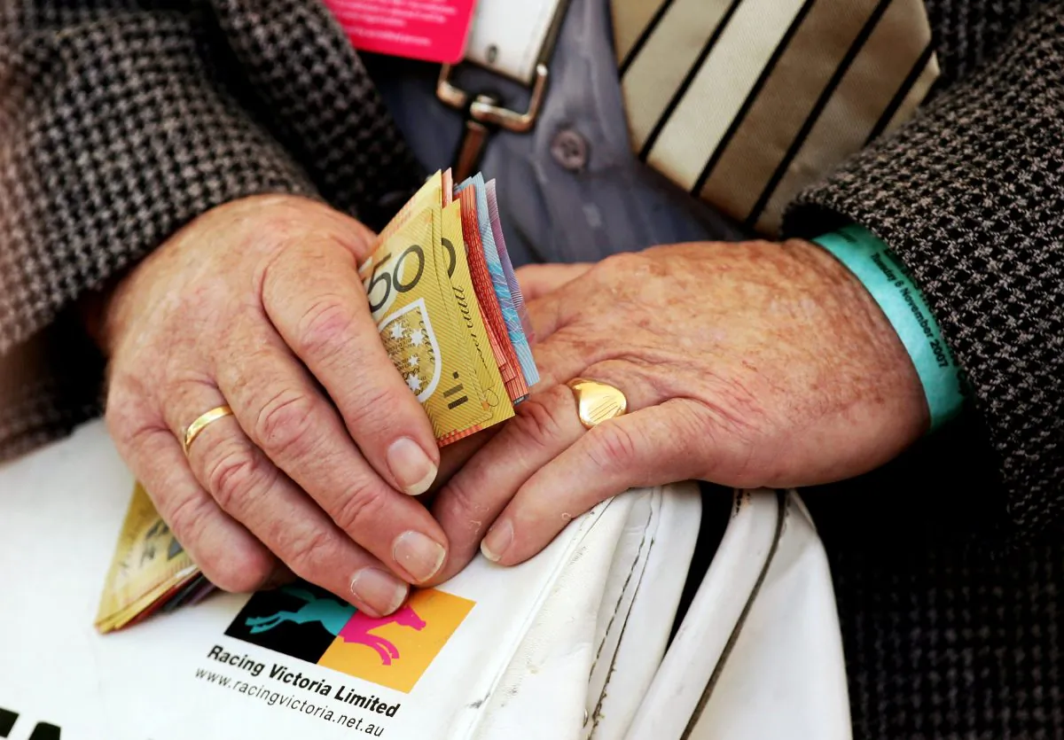 A bookie holds money at The Melbourne Cup Carnival meeting at Flemington Racecourse Nov. 6, 2007 in Melbourne, Australia. (Quinn Rooney/Getty Images)