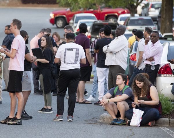 People gather across from the campus of UNC Charlotte