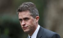UK’s May Fires Defense Secretary Over Huawei Leak