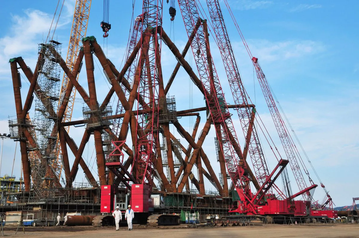 Chinese workers walk at an offshore oil engineering platform in Qingdao, east China's Shandong Province on Sept. 1, 2016.
(STR/AFP/Getty Images)