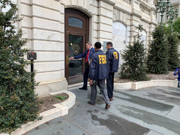 Federal Bureau of Investigation and Internal Revenue Service agents enter City Hall