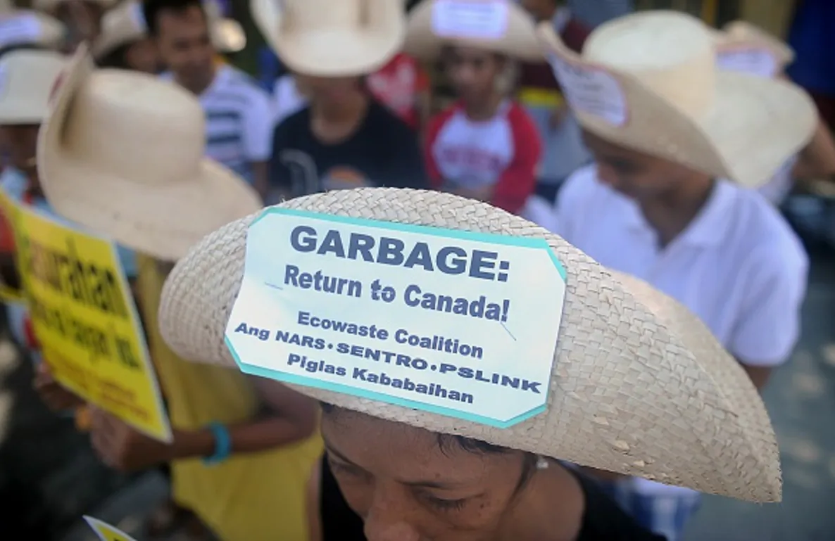 Environmental activists rally outside the Philippine Senate in Manila to demand that scores of containers filled with household rubbish be shipped back to Canada and to push for the ratification of the Basel Ban Amendment which prohibits the export of hazardous waste from developed to developing countries ,on Sept. 9, 2015. (Jay Directo/AFP/Getty Images)