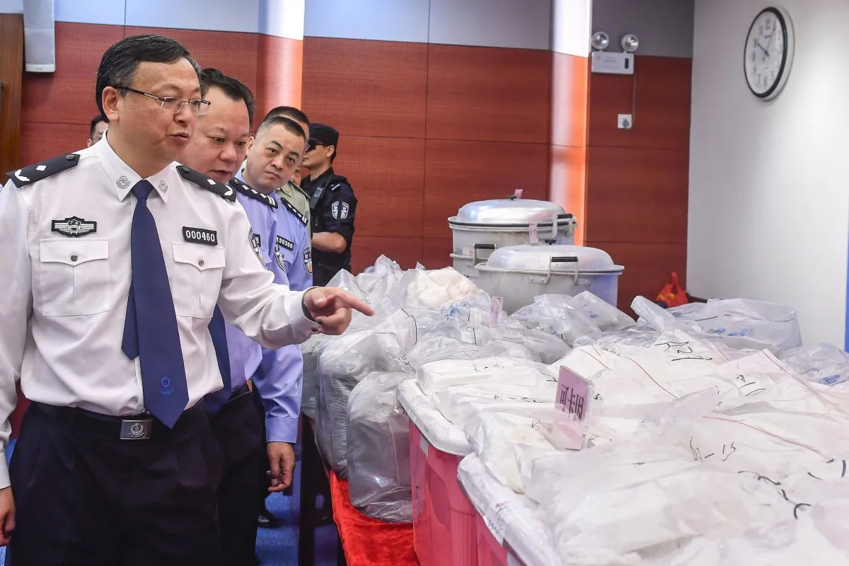 Police officers look at bags of cocaine seized in Guangzhou, Guangdong Province, China on April 24, 2018. (AFP/Getty Images)