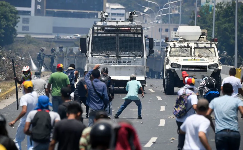 Demonstrators clash with soldiers loyal to Venezuelan dictator Nicolás Maduro after troops joined leader Juan Guaidó in his campaign to oust Maduro's government, in the surroundings of La Carlota military base in Caracas on April 30, 2019. (Federico Parra/AFP/Getty Images)