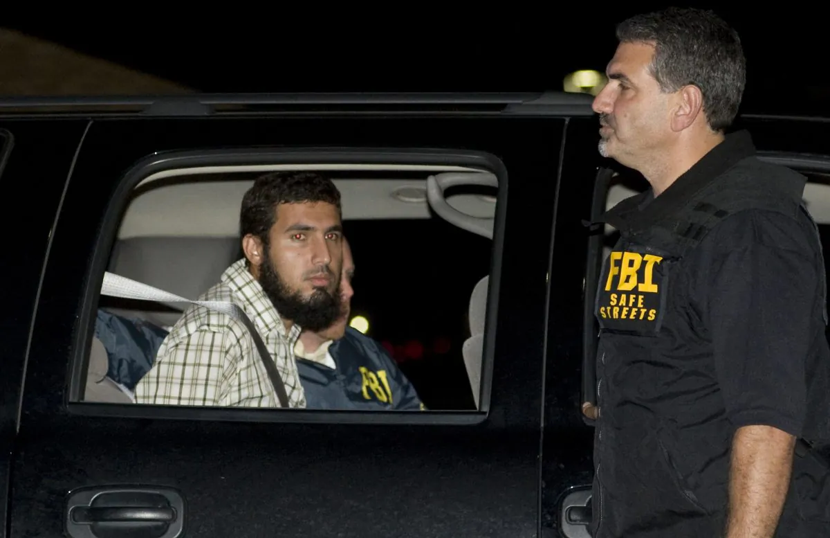 Terrorism suspect Najibullah Zazi is seated in an FBI vehicle after being arrested by the FBI in Aurora, Colo. on Sept. 19, 2009. (Chris Schneider/The Denver Post via AP, File)