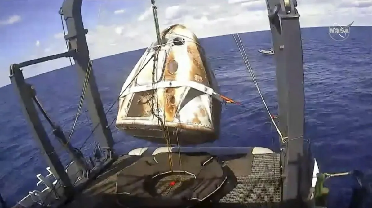 The SpaceX Crew Dragon capsule is hoisted onto a ship in the Atlantic Ocean off the Florida coast after it returned from a mission to the International Space Station on March 8, 2019. (NASA via AP, File)