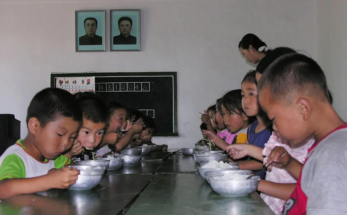 North Korean children eat lunch at a government run kindergarten at Taedong county in North Korea on July 18, 2005. (Gerald Bourke/World Food Program via Getty Images)