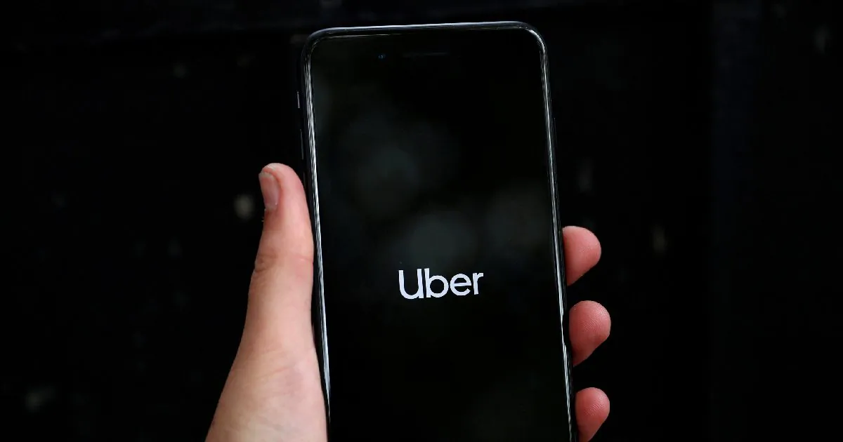 Uber's logo is displayed on a mobile phone in London, Britain, Sept. 14, 2018. (Hannah Mckay/Reuters)