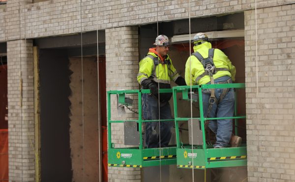 Construction workers are seen at a building site in New York City