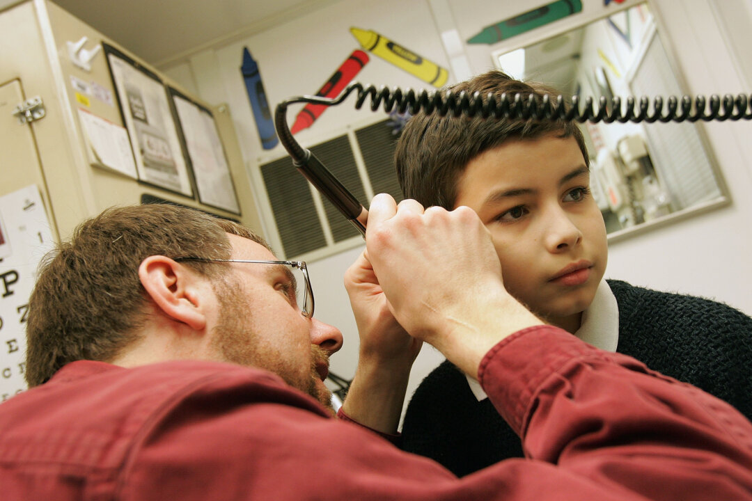 In this file image, a  boy, receives an ear exam in Cicero, Illinois on Feb. 22, 2005. (Tim Boyle/Getty Images)