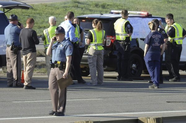 Emergency personnel work at the scene of a deadly collision on Interstate 70