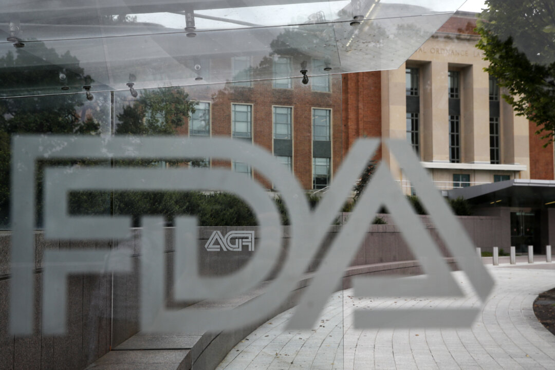 The U.S. Food and Drug Administration building behind FDA logos at a bus stop on the agency’s campus in Silver Spring, Md., on Aug. 2, 2018. (Jacquelyn Martin/AP)