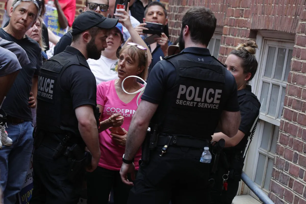U.S. Secret Service officers stop activists of an embassy protection group, including Medea Benjamin of Code Pink, from approaching a back entrance of the Embassy of Venezuela during a confrontation with Venezuelan opposition leader Juan Guaido supporters in in Washington, on May 2, 2019. (Alex Wong/Getty Images)