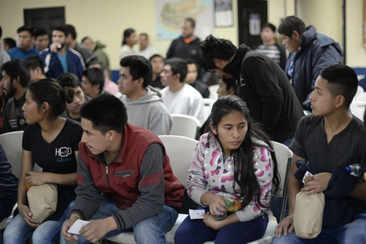 A group of 228 immigrants deported from the United States wait their turn to be registered by migration authorities upon their arrival at the Air Force base in Guatemala City on Jan.10, 2018.
(Johan Ordonez/AFP/Getty Images)