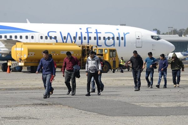 Members of a group of 228 Guatemalan immigrants deported from the United States arrive at the Air Force