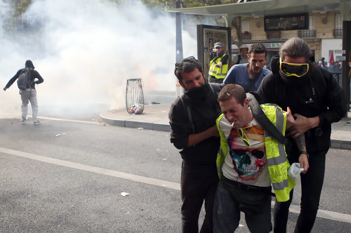 An injured demonstrator is helped during a May Day rally in Paris, Wednesday, May 1, 2019. (Francois Mori/AP)