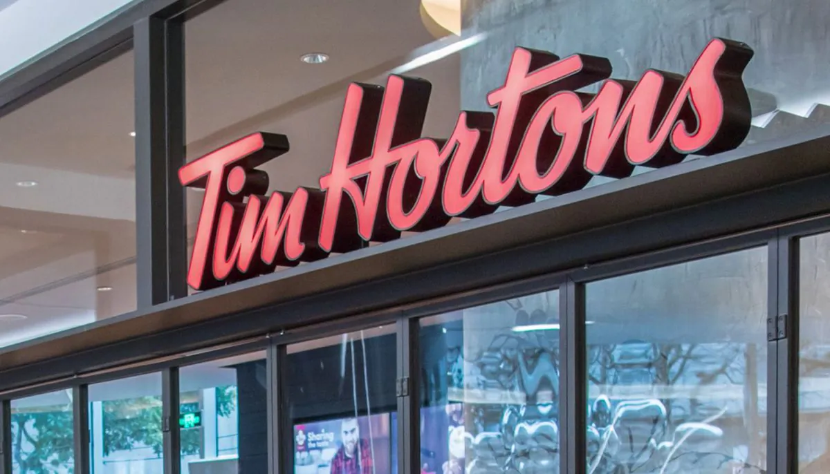 A Tim Hortons sign is seen at the front of the coffeehouse in a file photo. (STR/Gettty Images)