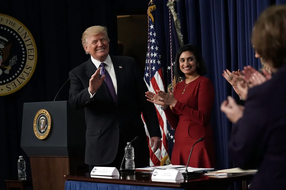 President Donald Trump (L) acknowledges the audience as Administrator of the Centers for Medicare and Medicaid Services Seema Verma (2nd L) looks on in the Eisenhower Executive Office Building in Washington on Jan. 18, 2018. (Alex Wong/Getty Images)