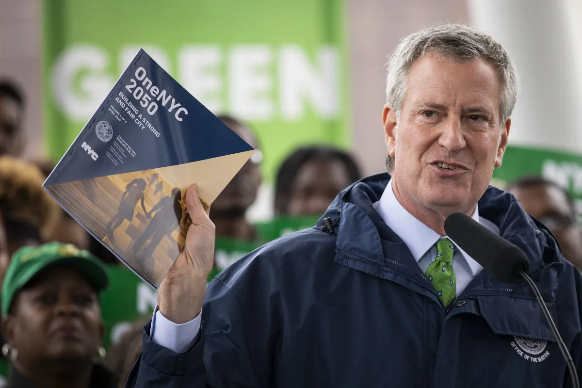 New York City Mayor Bill de Blasio holds up a copy of 'One NYC 2050' as he speaks at Hunters Point South Park in the Queens borough of New York City on April 22, 2019. (Drew Angerer/Getty Images)